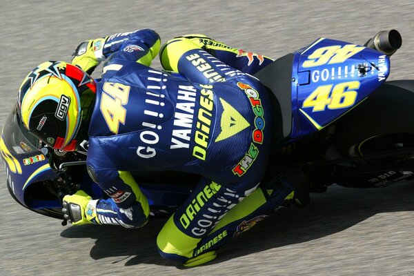 A motorcyclist in a blue suit on the track