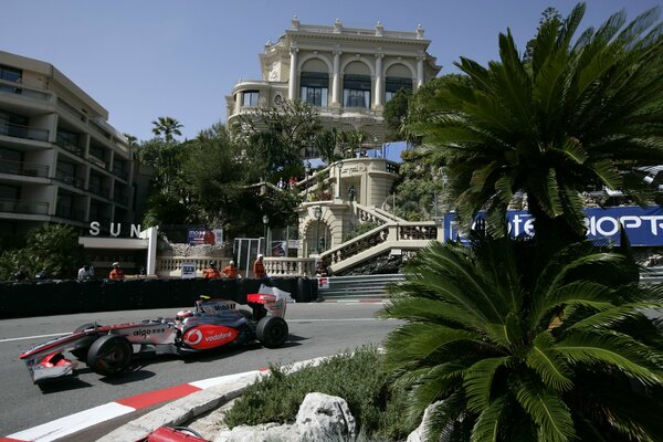 Formula 1 racing car on the Malaysian Grand Prix circuit against the backdrop of a luxurious palace in Sepang