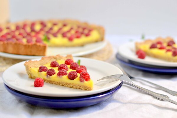 Lemon tart with raspberries and mint leaf