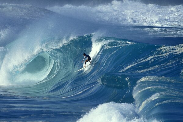 A lonely man conquers huge waves in the ocean