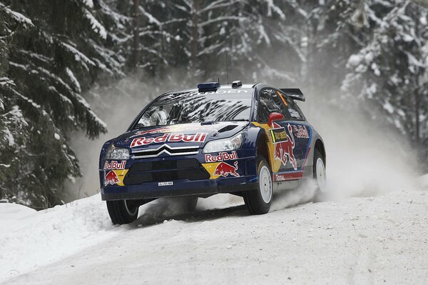 Rally on a snowy road in a blue car