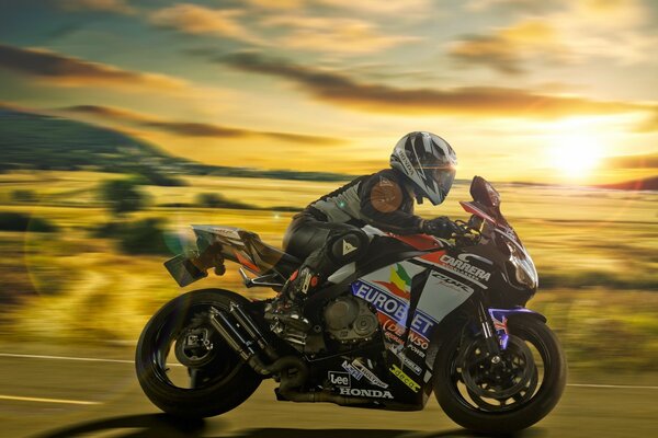 A motorcyclist rushes along the highway