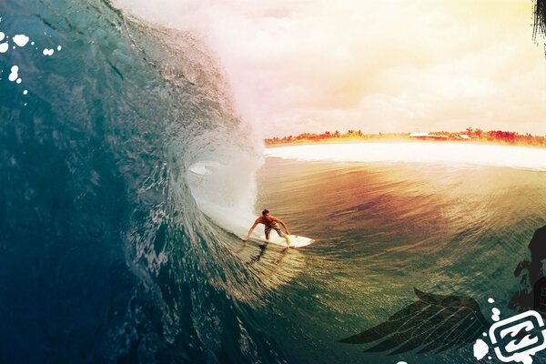 Surfer in the ocean catches a powerful wave