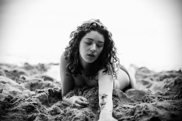 Girl on the beach in black and white shades