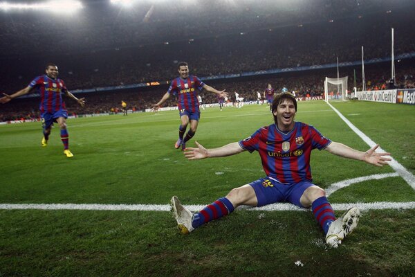 Football players laugh on the field after a goal