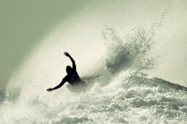 A skateboarder emerges from a foam wave