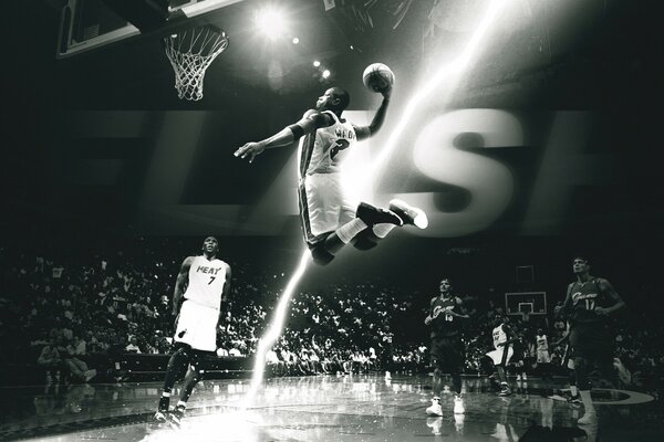 A man plays basketball and throws a ball into the ring