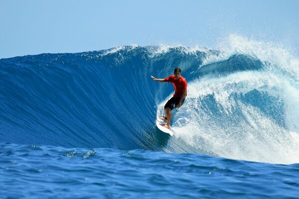 Male surfer catches ocean wave