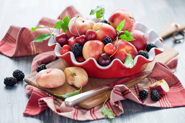 Assorted fruits and berries on a curly plate