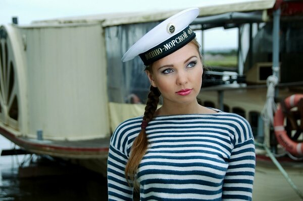 A model girl in a vest and a cap