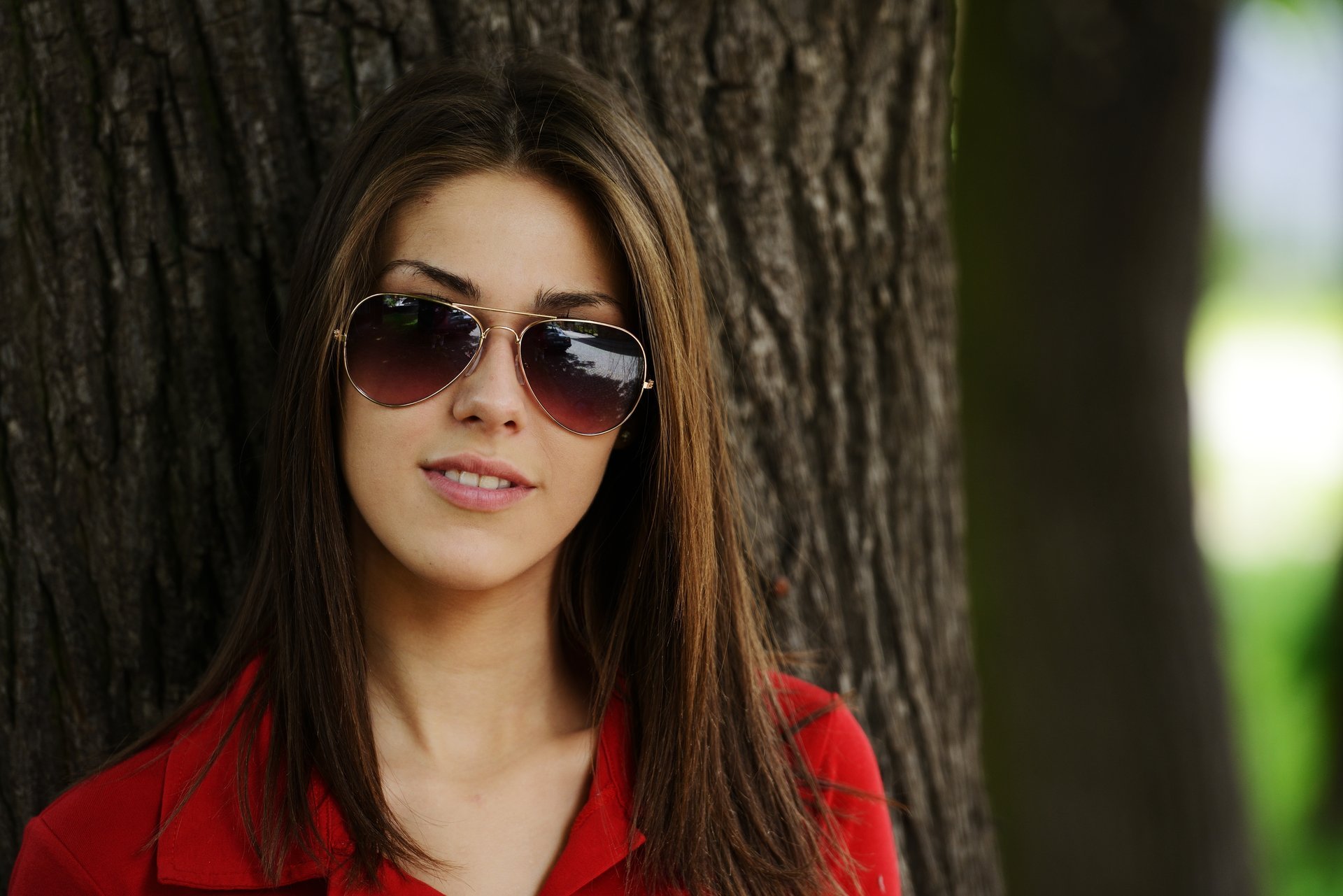 girl brown hair sunglasses tree