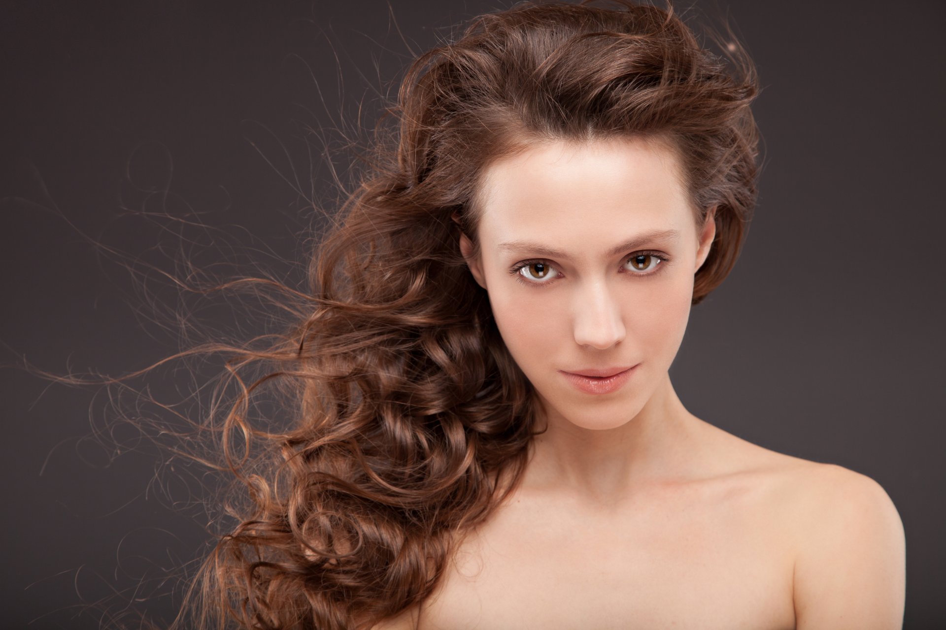 girl brown eyes view hair wavy curls wind background