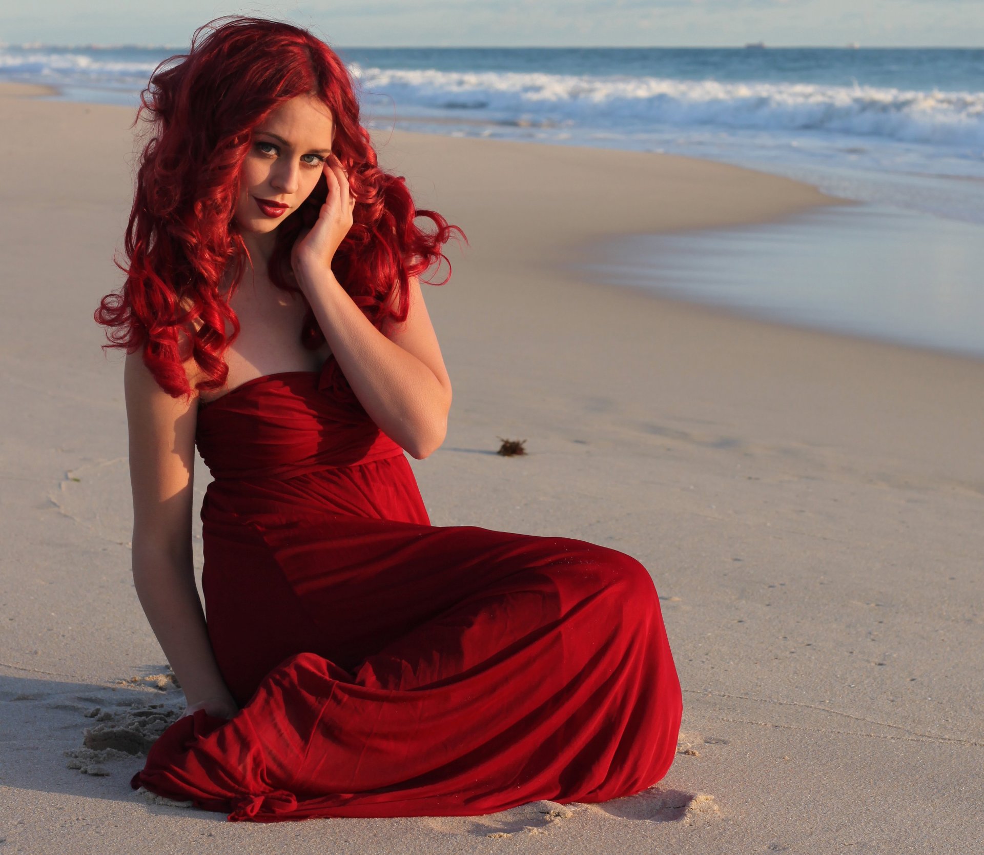 girl red hair curls make-up lipstick red dress sea sand