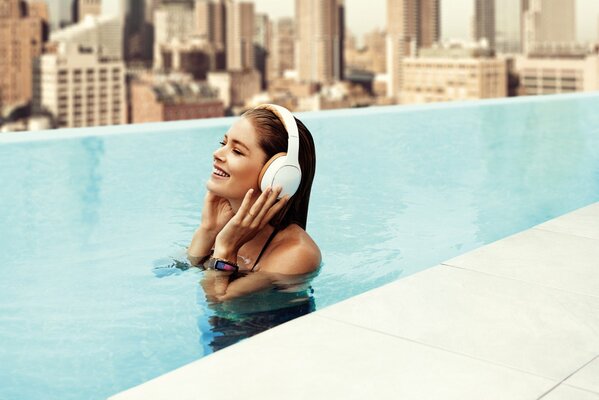 Brunette in the water listening to music with headphones