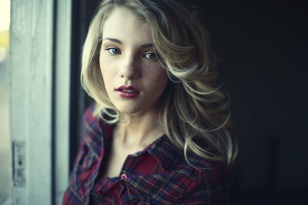 Blonde girl in a plaid shirt