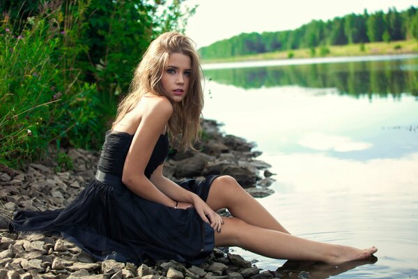 Ksenia Kokoreva on the shore by the water