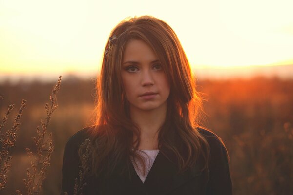 Chest photo of Ksenia Kokoreva against the background of nature at sunset