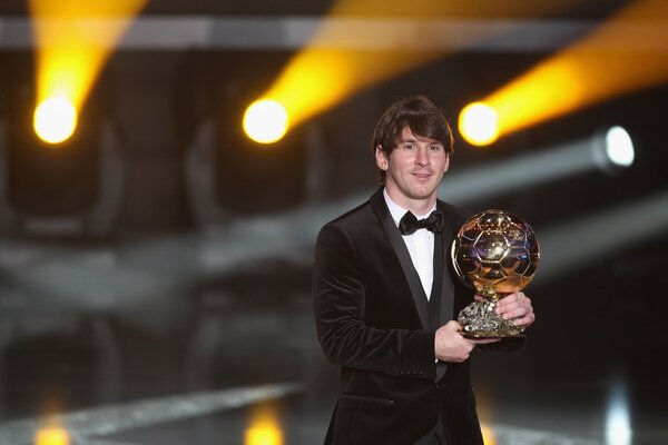 Messi hält den goldenen Ball in der Hand