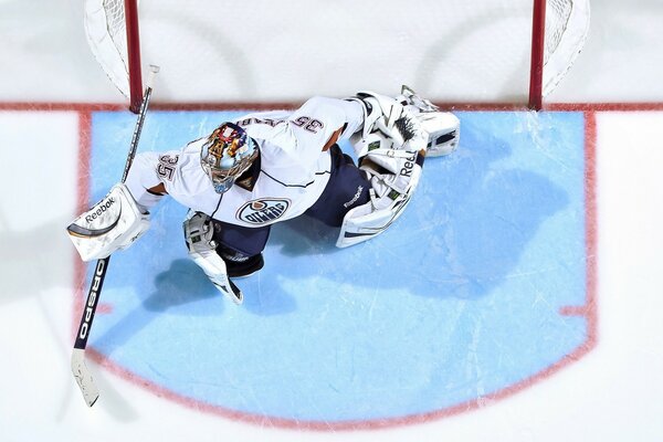 The goalkeeper on the gate during a game of hockey