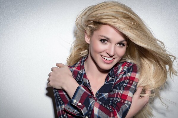 Blonde girl in a plaid shirt