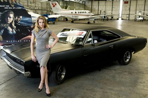 Amber Heard on the background of a black car