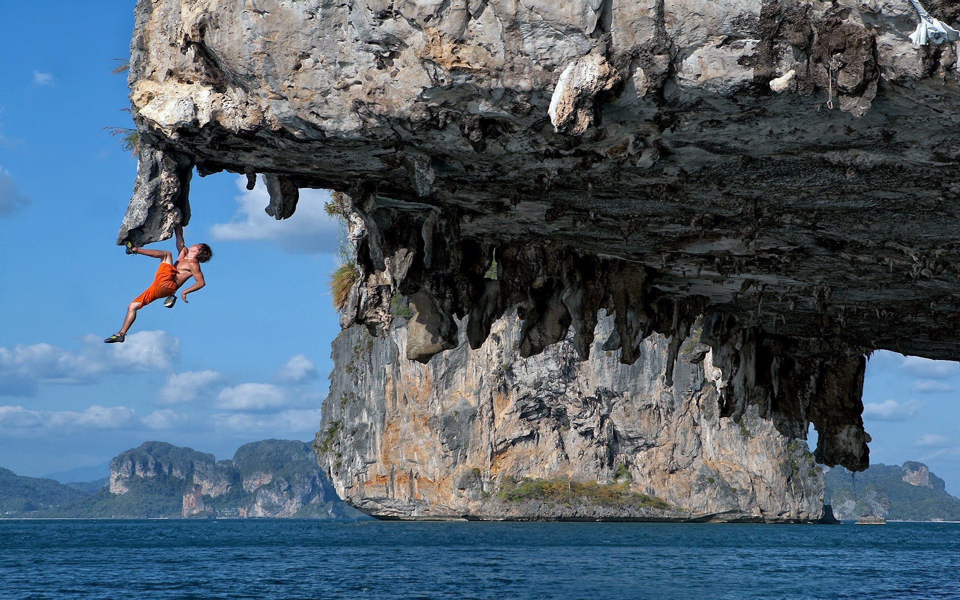 man rock amber eyes blue water sea sports ocean