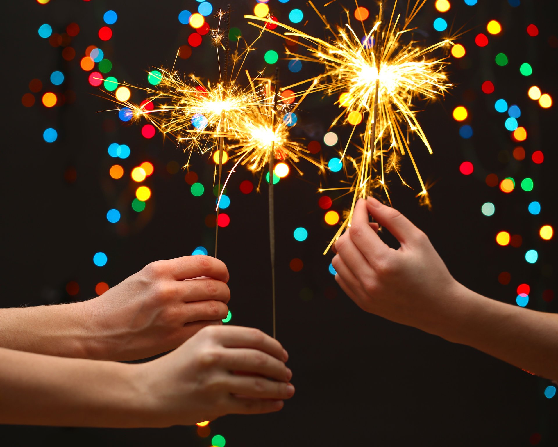 celebrate merry christmas little girls sparklers new year lights kids hands bokeh