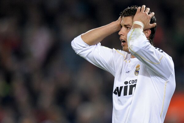 Cristiano Ronaldo holds his head on the pitch