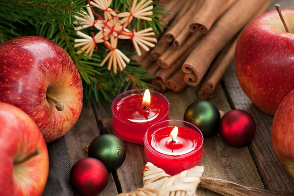 Christmas theme with apples candles and cinnamon