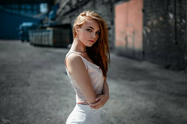 Beautiful girl on the background of an industrial landscape