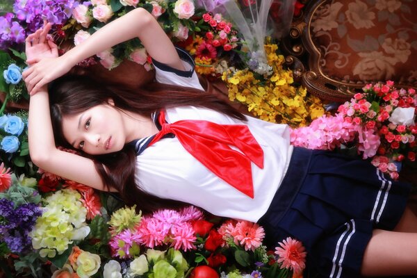 Asian girl lies in flowers