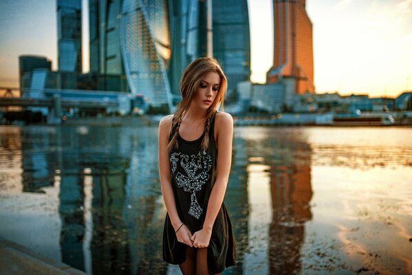 A lonely girl on the background of Moscow skyscrapers