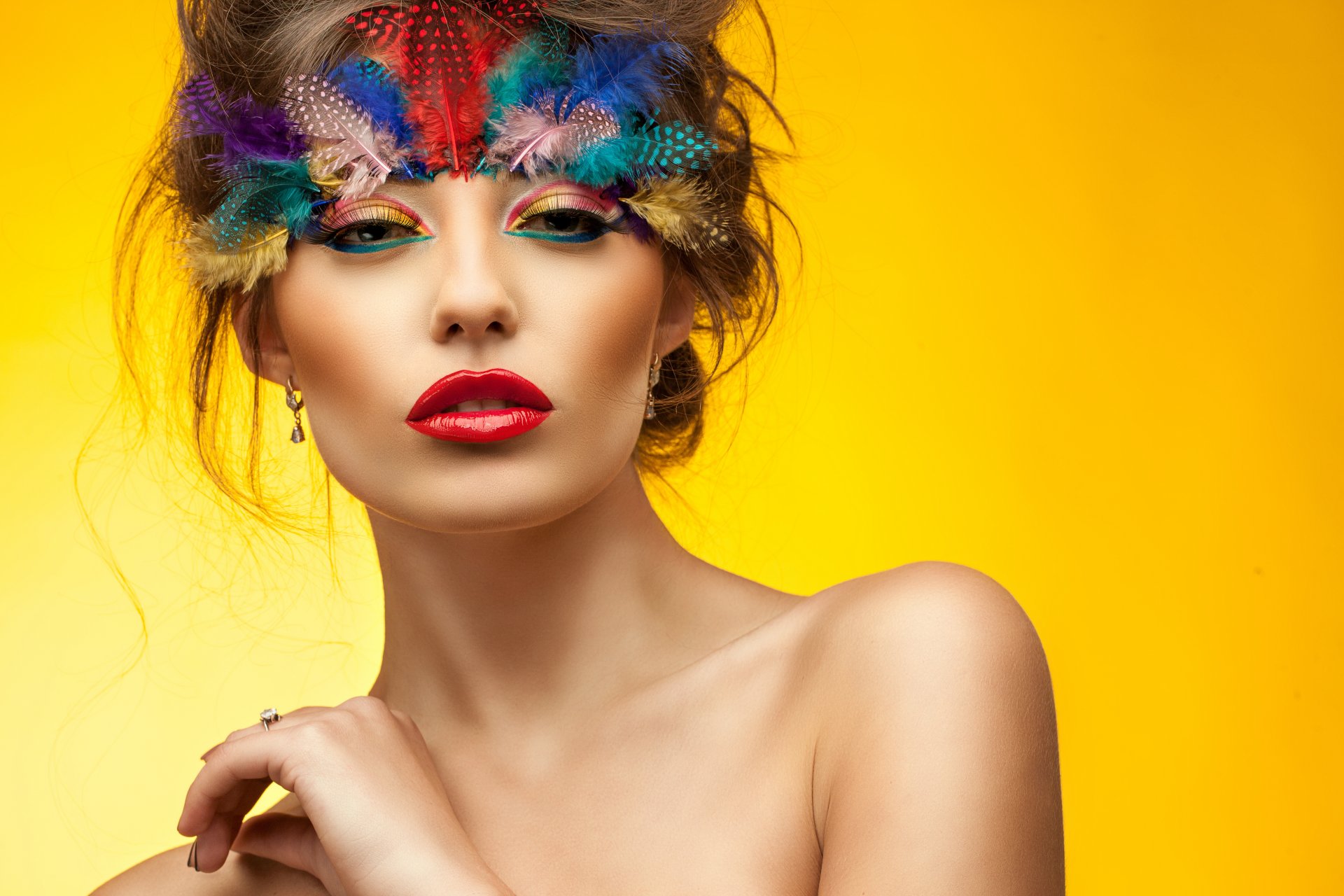 girl make-up view eyes face red lips feathers hand neck shoulders yellow background