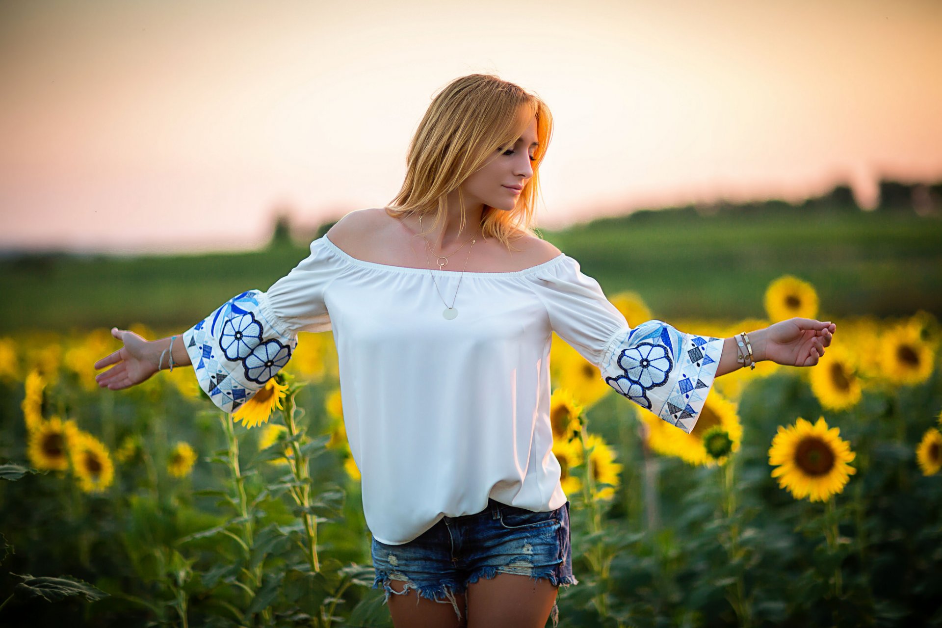 girl face hair shorts sunflowers the field summer