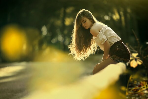 A girl with long hair looks down