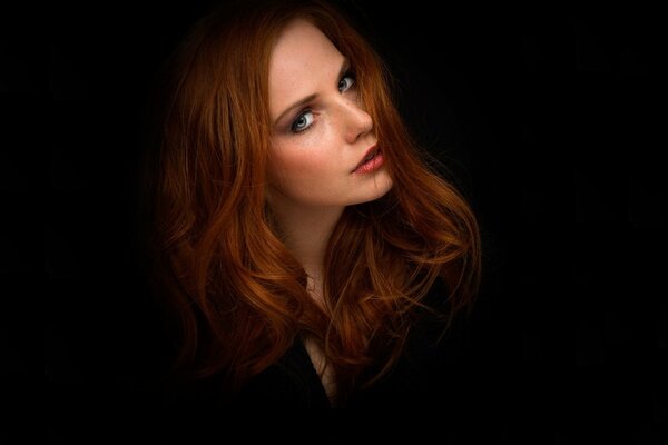 Red-haired girl on a black background