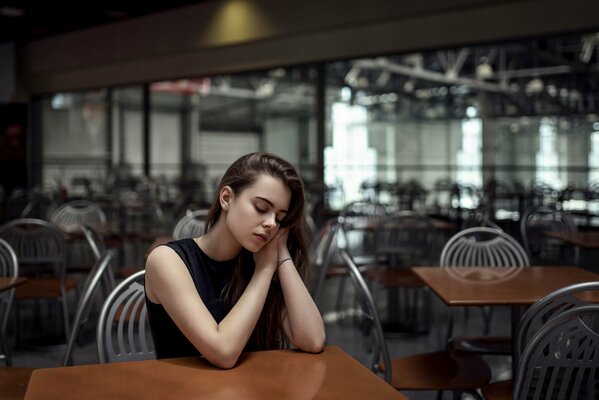 A calm girl in a cafe at a table