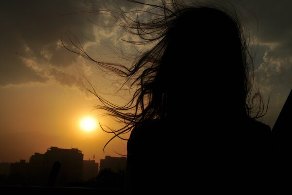 Landscape of a girl in the sunset sky