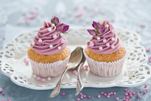 Cupcakes with cream turrets on an openwork plate