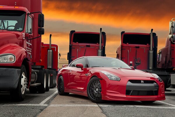 Red car in the truck parking lot