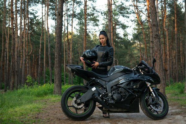 Brunette in the woods on a sport bike