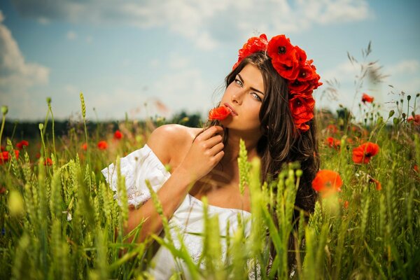 A girl in a field with red poppies