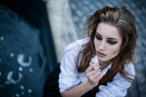 A girl on the street posing with bright makeup