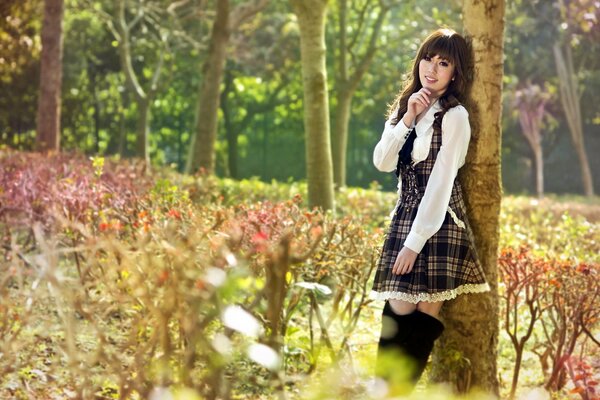 A girl walking through a summer forest