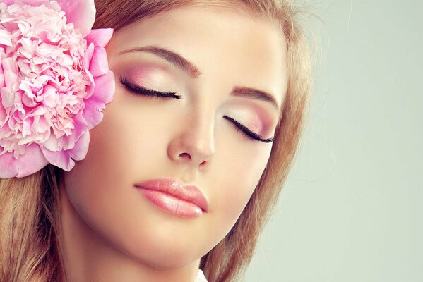 Beautiful girl with pink flower