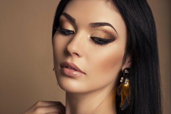 Model with makeup in gold tones