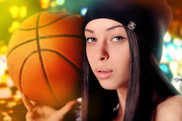 Mädchen in einer Mütze mit einem Basketball