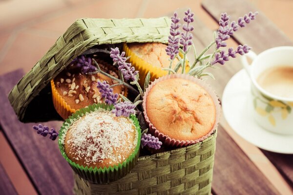 Cupcakes in a wicker basket with a sprig of lavender