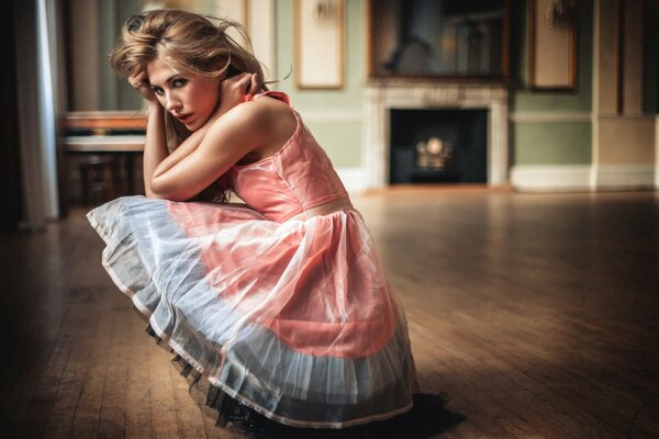 A lovely girl in a magnificent dress in the house