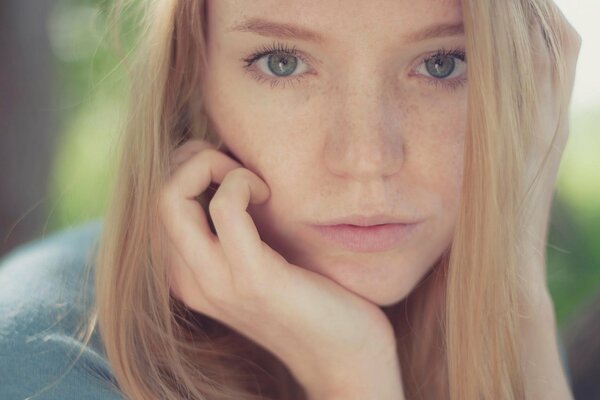 Blonde girl looks at the camera